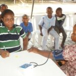Image of people recieving medical attention during one of the outreach program